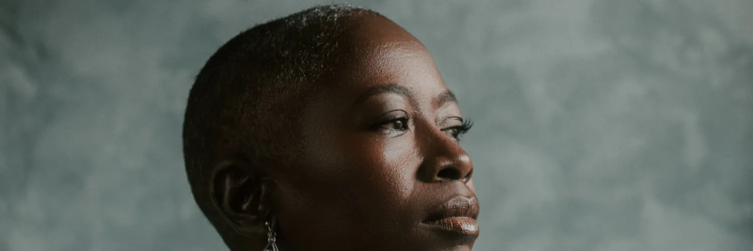 The author looking to the right, against a grey background